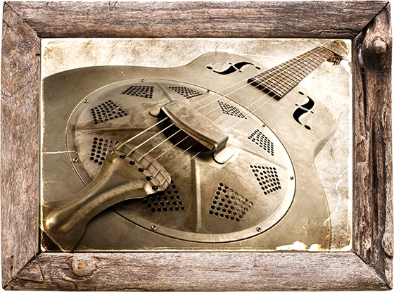 A framed photo of a resonator guitar